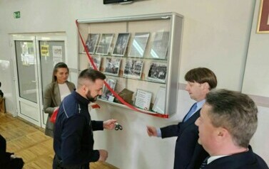 Zaproszeni goście odsłaniają pamiątkową gablotę poświęconą J&oacute;zefowi Jaroniowi, kierownikowi Publicznej Szkoły Powszechnej nr 2 w Staszowie w latach 1929-1939