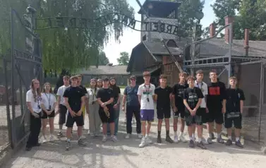 &Oacute;smoklasiści wraz z opiekunami przed bramą obozu w Auschwitz