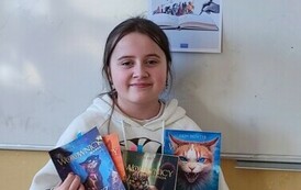 Uczennica klasy 5c prezentująca swoje czytelnicze skarby