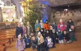 Wsp&oacute;lne zdjęcie uczni&oacute;w klasy 1 b pod całoroczną stajenką w Kopalni Soli Bochnia
