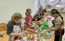 Dzieci z klasy 2 b w skupieniu wycinają kształty ciasteczek