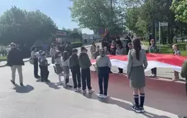 Harcerze niosący flagę przygotowują się do przemarszu