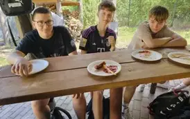 Trzej uczniowie przy stole