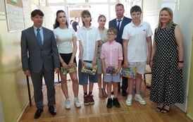 Grupa pięciorga uczni&oacute;w z nagrodami, z lewej dyrektor, z prawej wicedyrektor i nauczycielka