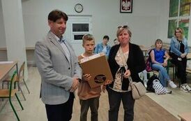 3Dyrektor szkoły, czwartoklasista trzymający laptop, matka chłopca