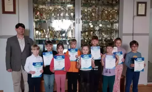 Laureaci konkursu stoją z dyplomami obok Dyrektora szkoły